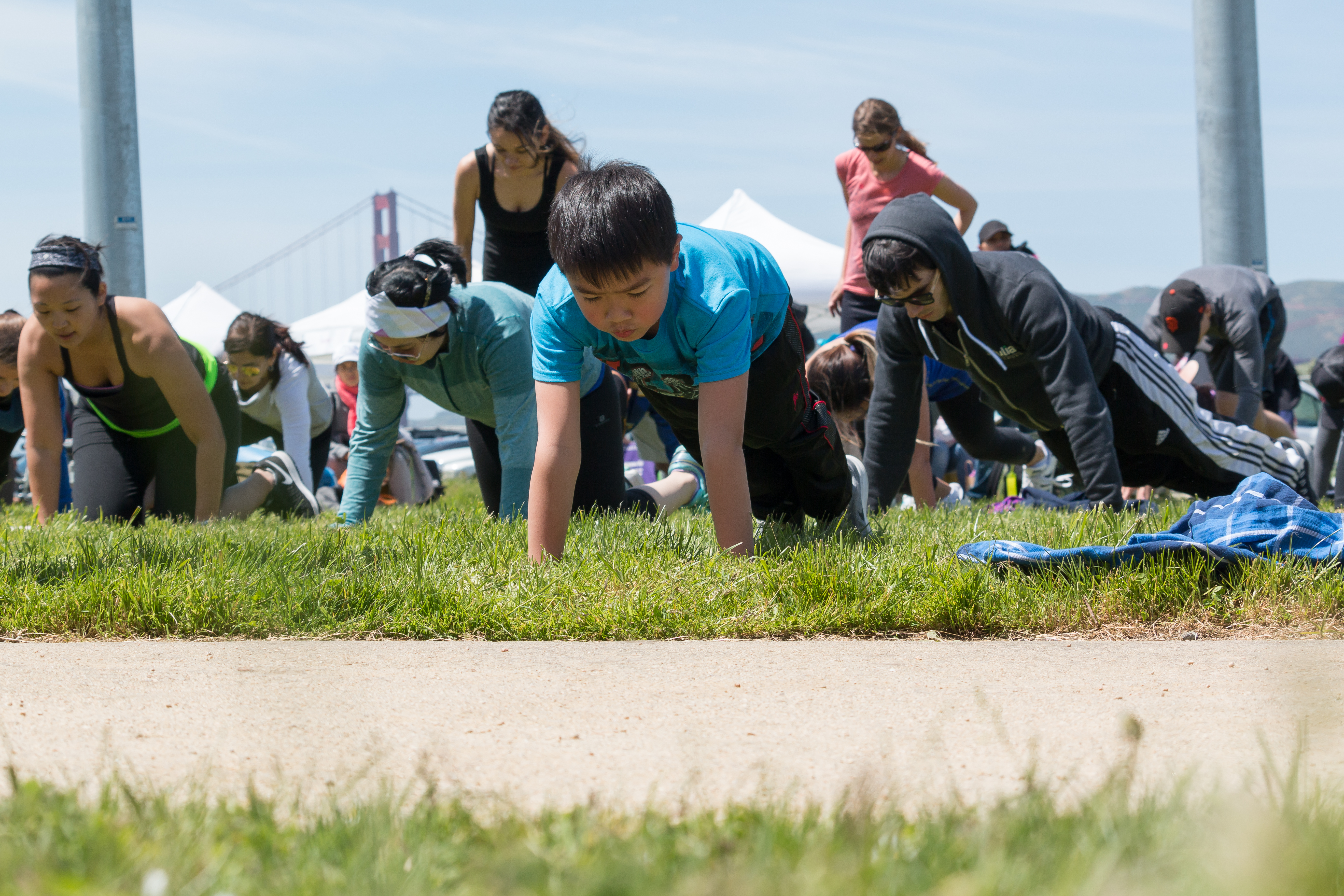 Kid and others doing push ups