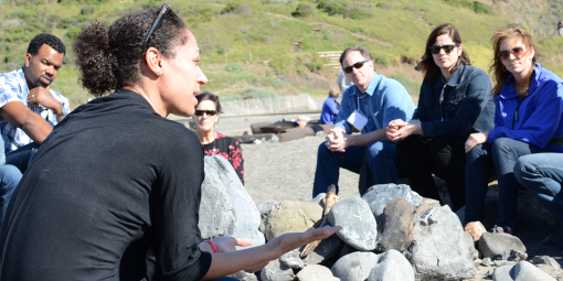 Group talking on beach.